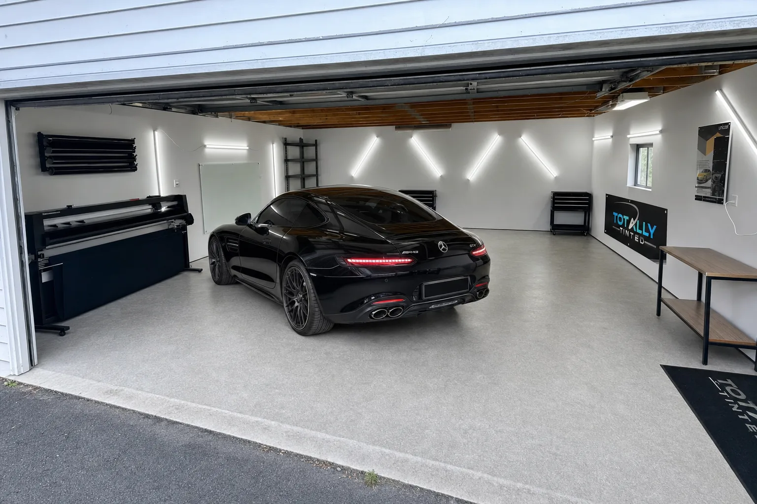 Gloss black Mercedes-AMG GT with freshly tinted windows in the Totally Tinted garage studio