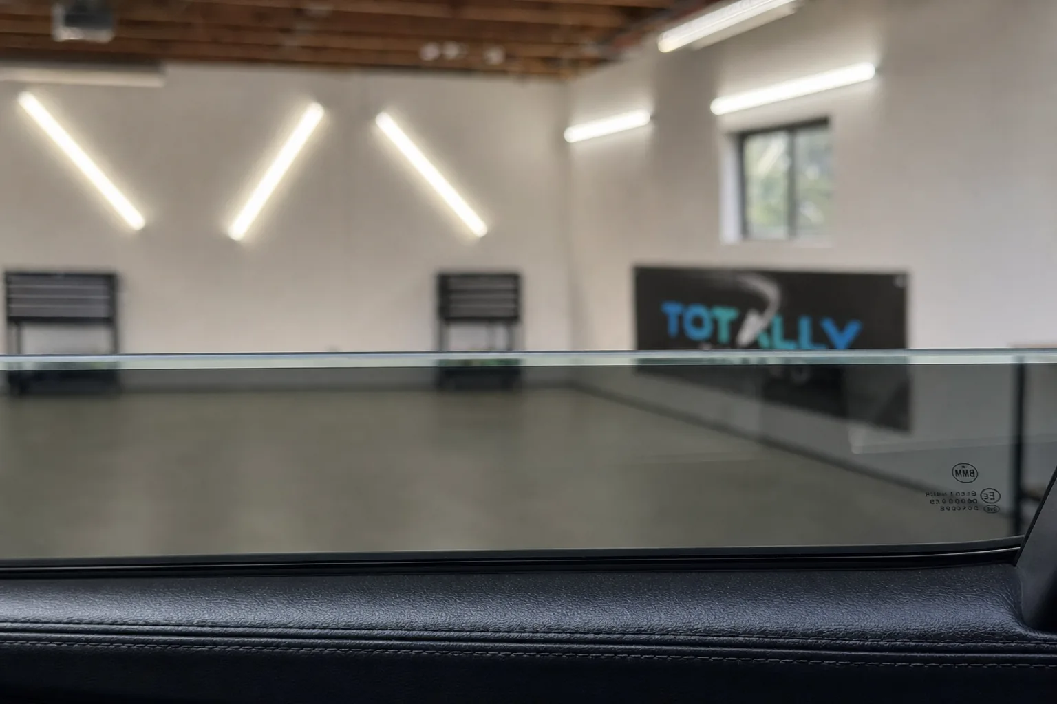 The view through a freshly tinted side window from inside a car in the Totally Tinted studio