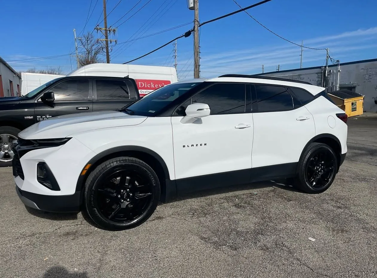 A white Chevrolet Blazer with tinted windows, a Totally Tinted job