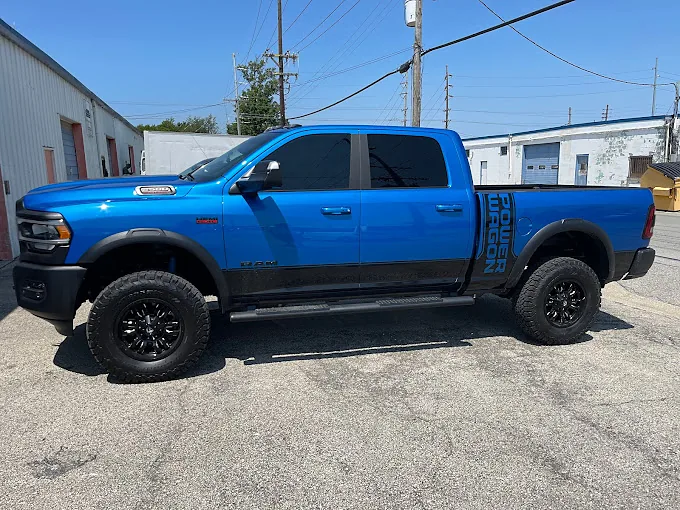 A blue Ford pickup with tinted windows, a Totally Tinted job