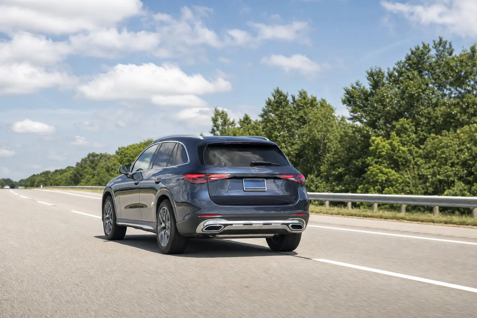 A navy Mercedes SUV on an Indiana highway in clear daylight